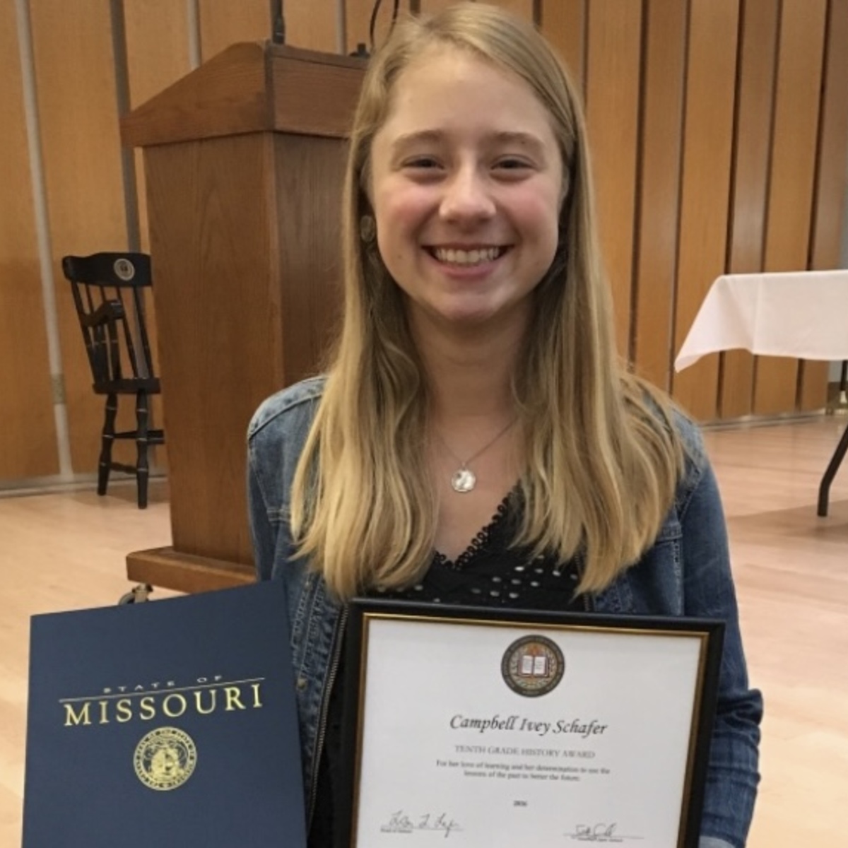 Campbell Schafer, Co-Founder and COO of EducAIte, holding her tenth grade history award